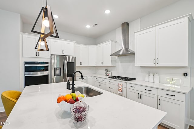 772 Mirkwood Ave, Apex, NC 27523 - kitchen featuring appliances with stainless steel finishes, wall chimney range hood, white cabinetry, pendant lighting, and recessed lighting