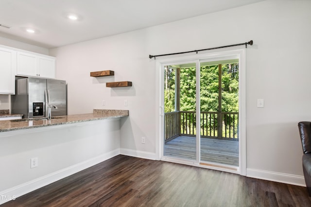 933 Weatherby Ln, Creedmoor, NC 27522 - kitchen with stainless steel fridge, dark wood finished floors, white cabinetry, light stone countertops, and recessed lighting