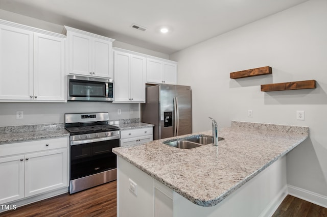 933 Weatherby Ln, Creedmoor, NC 27522 - kitchen with stainless steel appliances, a peninsula, open shelves, dark wood finished floors, and white cabinets