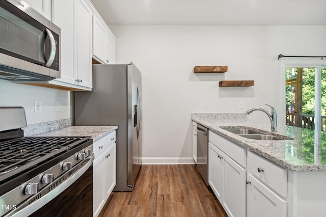 933 Weatherby Ln, Creedmoor, NC 27522 - kitchen featuring appliances with stainless steel finishes, dark wood-type flooring, white cabinets, open shelves, and light stone countertops