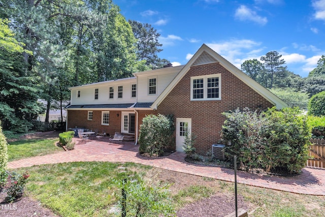 2204 Basil Dr, Raleigh, NC 27612 - rear view of house with central AC, a patio area, brick siding, and entry steps