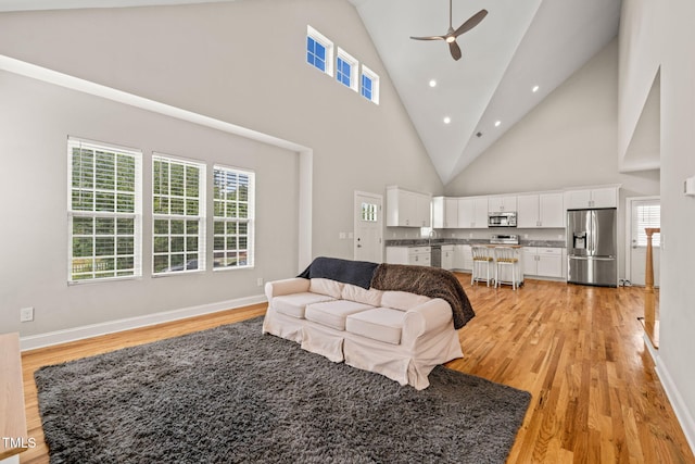 225 E End Ave, Durham, NC 27703 - living area with light wood-type flooring, ceiling fan, plenty of natural light, high vaulted ceiling, and recessed lighting