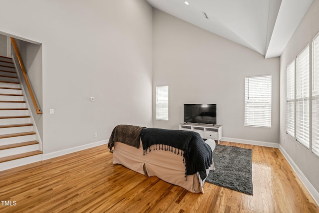 225 E End Ave, Durham, NC 27703 - living room featuring stairway, plenty of natural light, light wood-type flooring, and high vaulted ceiling