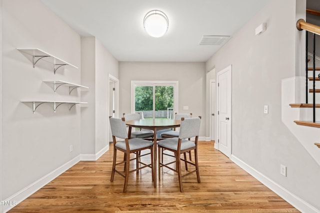 225 E End Ave, Durham, NC 27703 - dining space with stairway, light wood finished floors, and baseboards