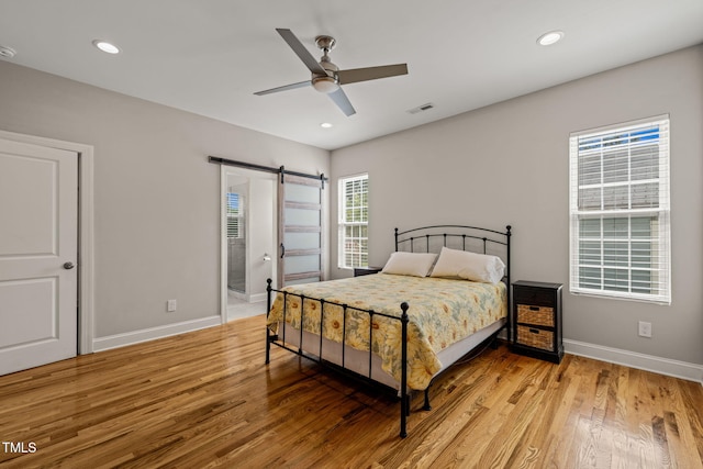 225 E End Ave, Durham, NC 27703 - bedroom featuring a barn door, light wood-type flooring, baseboards, recessed lighting, and a ceiling fan