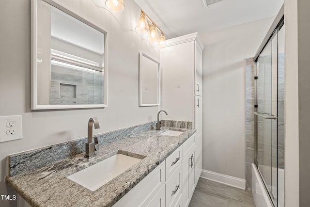 225 E End Ave, Durham, NC 27703 - full bathroom featuring double vanity, baseboards, and combined bath / shower with glass door