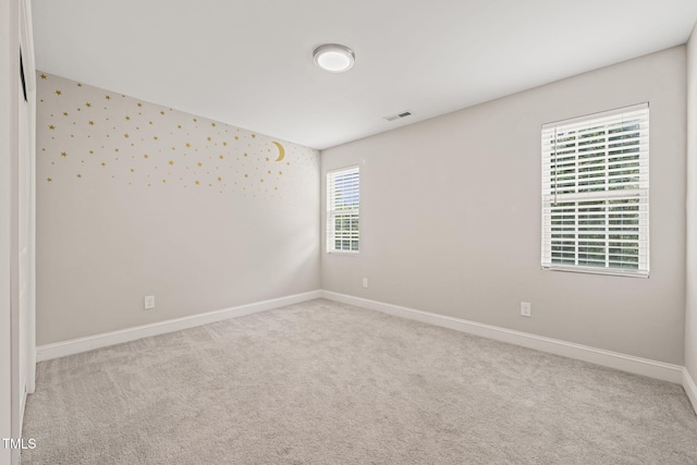 225 E End Ave, Durham, NC 27703 - carpeted spare room with baseboards, wallpapered walls, and an accent wall