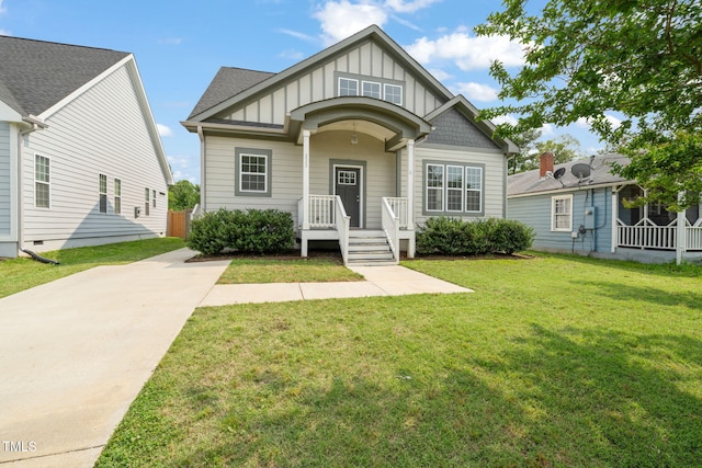 225 E End Ave, Durham, NC 27703 - view of front of home featuring board and batten siding, a front lawn, and driveway