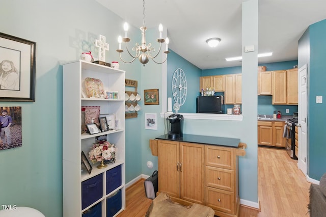 8620 Neuse Club Ln Unit 107, Raleigh, NC 27616 - kitchen featuring refrigerator, light wood finished floors, stainless steel gas range oven, and a chandelier