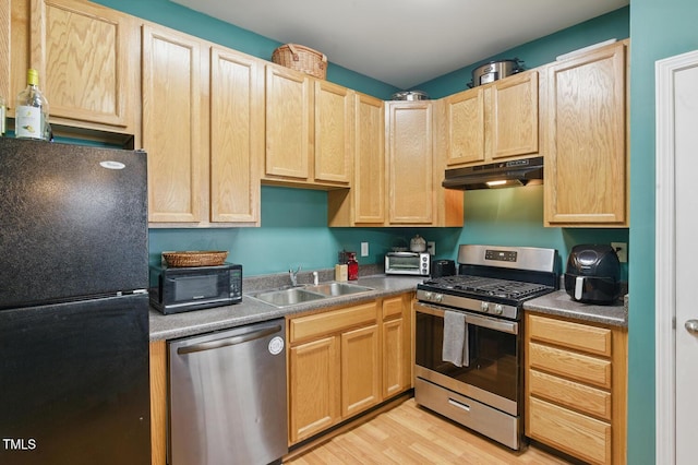 8620 Neuse Club Ln Unit 107, Raleigh, NC 27616 - kitchen with black appliances, under cabinet range hood, and light brown cabinetry