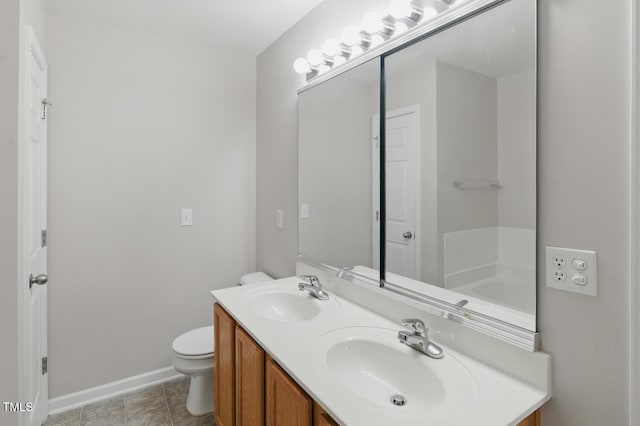 8620 Neuse Club Ln Unit 107, Raleigh, NC 27616 - bathroom with double vanity and baseboards