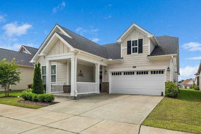 512 Courtship Cv, Durham, NC 27703 - craftsman-style home featuring board and batten siding, covered porch, a front yard, brick siding, and concrete driveway