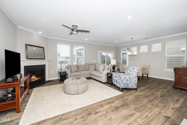 512 Courtship Cv, Durham, NC 27703 - living room featuring a chandelier, wood finished floors, a fireplace with flush hearth, ornamental molding, and ceiling fan