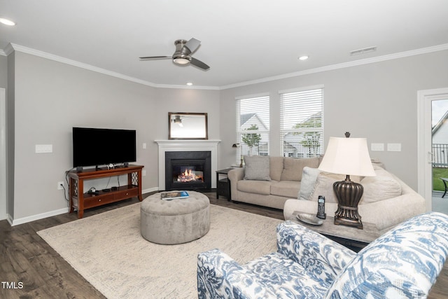 512 Courtship Cv, Durham, NC 27703 - living area with dark wood-style flooring, ceiling fan, crown molding, a glass covered fireplace, and recessed lighting