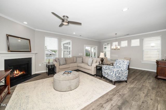 512 Courtship Cv, Durham, NC 27703 - living area featuring a chandelier, dark wood finished floors, a fireplace with flush hearth, ceiling fan, and crown molding