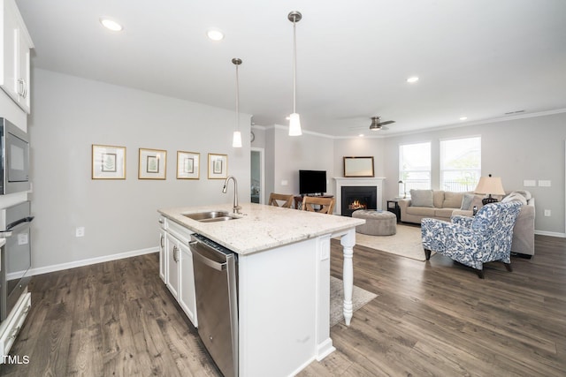 512 Courtship Cv, Durham, NC 27703 - kitchen with stainless steel appliances, ceiling fan, a warm lit fireplace, a breakfast bar area, and crown molding