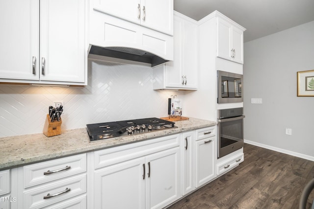 512 Courtship Cv, Durham, NC 27703 - kitchen with stainless steel appliances, tasteful backsplash, dark wood finished floors, white cabinetry, and light stone counters