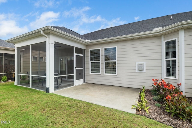 512 Courtship Cv, Durham, NC 27703 - rear view of property featuring a sunroom, a lawn, a patio, and a shingled roof