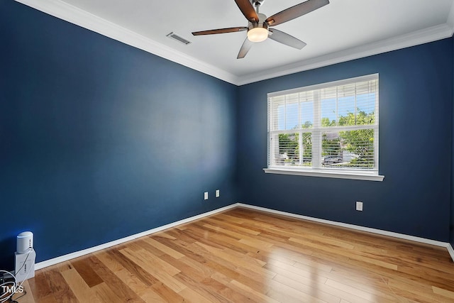 409 Kilcornac Ct, Fuquay Varina, NC 27526 - spare room featuring a ceiling fan, wood finished floors, baseboards, and crown molding