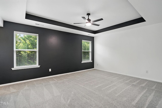409 Kilcornac Ct, Fuquay Varina, NC 27526 - empty room featuring a raised ceiling, a ceiling fan, carpet floors, and baseboards