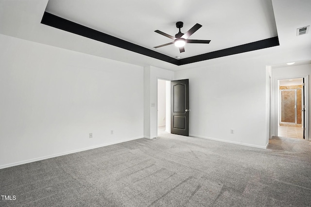 409 Kilcornac Ct, Fuquay Varina, NC 27526 - carpeted spare room featuring a raised ceiling, baseboards, and a ceiling fan