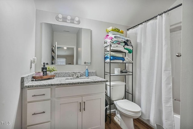 784 Crawford Rd, Coats, NC 27521 - bathroom featuring toilet, vanity, wood finished floors, and shower / bath combo