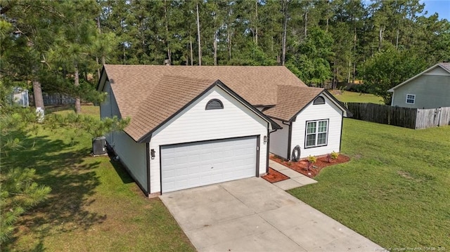 306 Longleaf Pines Dr, Raeford, NC 28376 - view of front of home with central AC, driveway, an attached garage, and a shingled roof