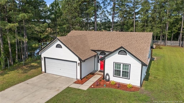 306 Longleaf Pines Dr, Raeford, NC 28376 - ranch-style house featuring concrete driveway, a garage, roof with shingles, and view of wooded area
