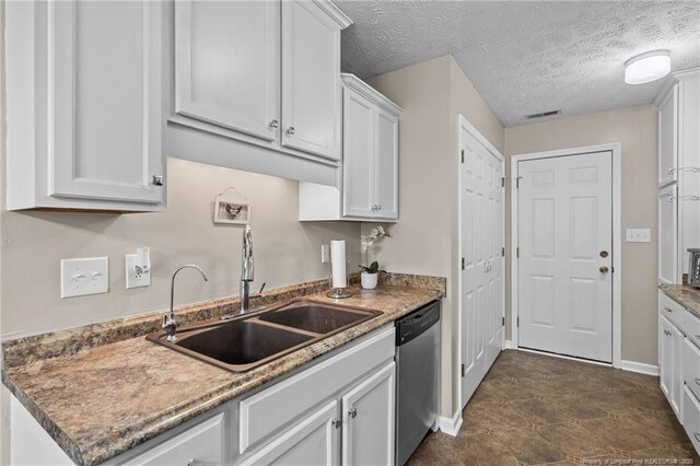 306 Longleaf Pines Dr, Raeford, NC 28376 - kitchen featuring stainless steel dishwasher, a sink, baseboards, white cabinets, and a textured ceiling
