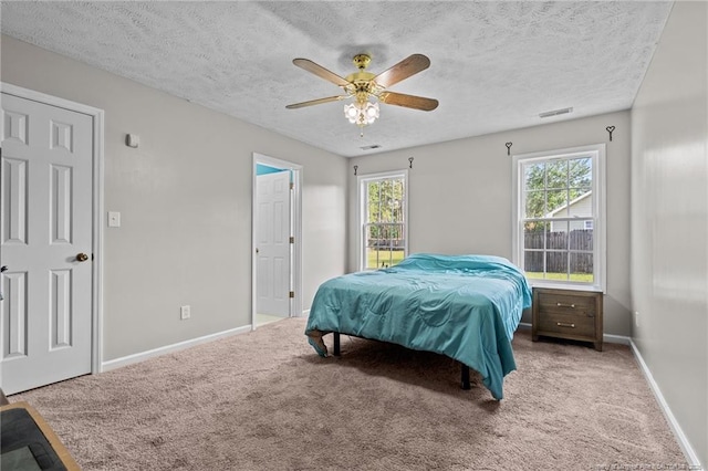 306 Longleaf Pines Dr, Raeford, NC 28376 - carpeted bedroom featuring multiple windows, a textured ceiling, baseboards, and ceiling fan