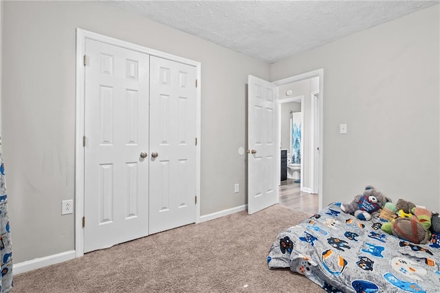 306 Longleaf Pines Dr, Raeford, NC 28376 - bedroom featuring carpet flooring, a textured ceiling, baseboards, and a closet