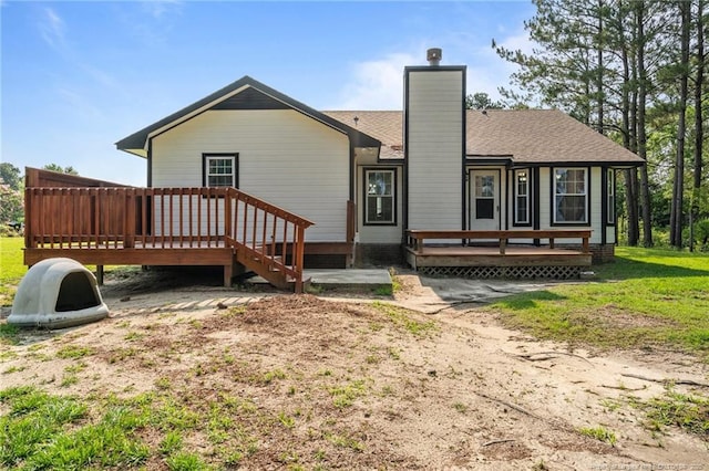 306 Longleaf Pines Dr, Raeford, NC 28376 - back of property featuring a deck, a chimney, and roof with shingles