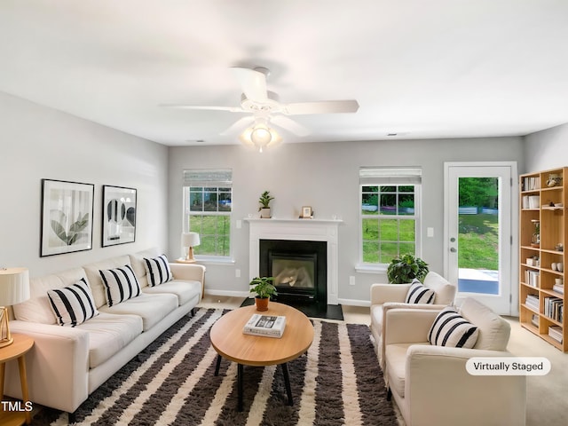 735 Sycamore Springs Dr, Fuquay Varina, NC 27526 - living room featuring ceiling fan, a fireplace with flush hearth, and baseboards