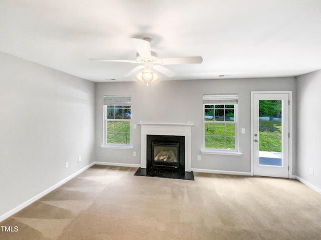 735 Sycamore Springs Dr, Fuquay Varina, NC 27526 - unfurnished living room featuring a fireplace with flush hearth, carpet, baseboards, and a ceiling fan