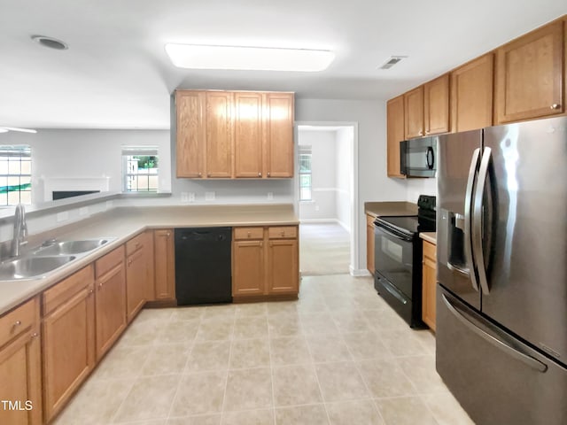 735 Sycamore Springs Dr, Fuquay Varina, NC 27526 - kitchen with black appliances, a sink, light countertops, and light tile patterned floors