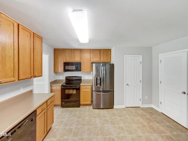 735 Sycamore Springs Dr, Fuquay Varina, NC 27526 - kitchen with black appliances, light countertops, baseboards, and light tile patterned floors