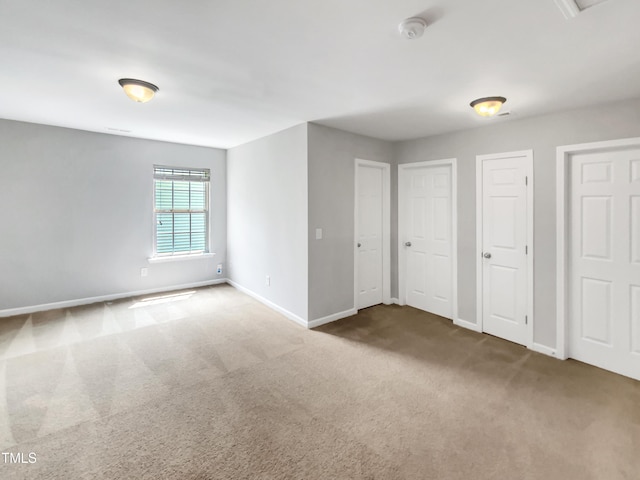 735 Sycamore Springs Dr, Fuquay Varina, NC 27526 - unfurnished bedroom featuring carpet floors, two closets, and baseboards