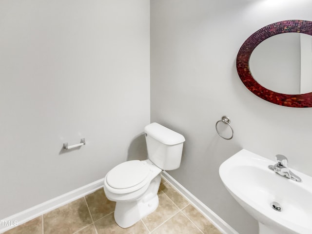 735 Sycamore Springs Dr, Fuquay Varina, NC 27526 - half bathroom featuring a sink, toilet, baseboards, and tile patterned floors
