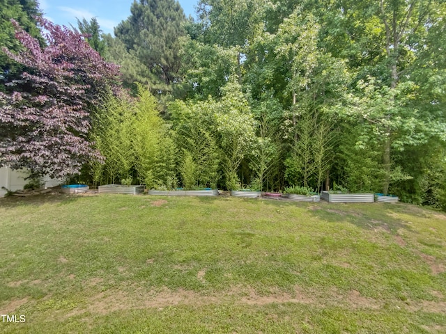 735 Sycamore Springs Dr, Fuquay Varina, NC 27526 - view of grassy yard featuring a vegetable garden