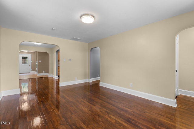 2712 Broad St, Durham, NC 27704 - spare room featuring arched walkways, hardwood / wood-style flooring, and baseboards