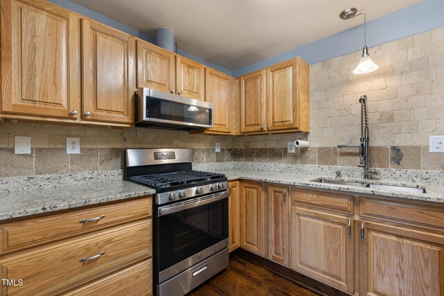 2712 Broad St, Durham, NC 27704 - kitchen with stainless steel appliances, a sink, light stone counters, and decorative backsplash