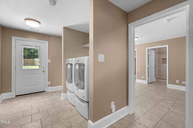 2712 Broad St, Durham, NC 27704 - laundry room with separate washer and dryer, baseboards, and stone tile floors