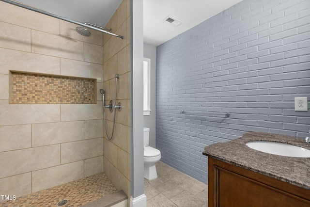 2712 Broad St, Durham, NC 27704 - full bathroom featuring toilet, vanity, tiled shower, and tile patterned floors