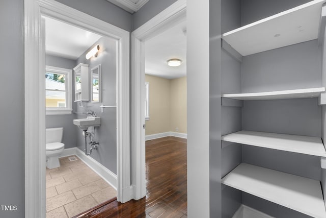 2712 Broad St, Durham, NC 27704 - bathroom with toilet, baseboards, and wood finished floors