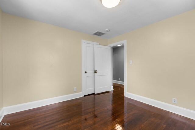 2712 Broad St, Durham, NC 27704 - unfurnished bedroom featuring baseboards and wood finished floors
