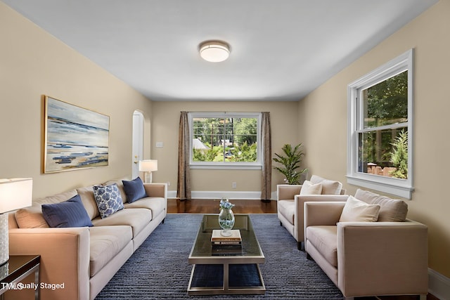 2712 Broad St, Durham, NC 27704 - living room featuring baseboards and dark wood-style floors