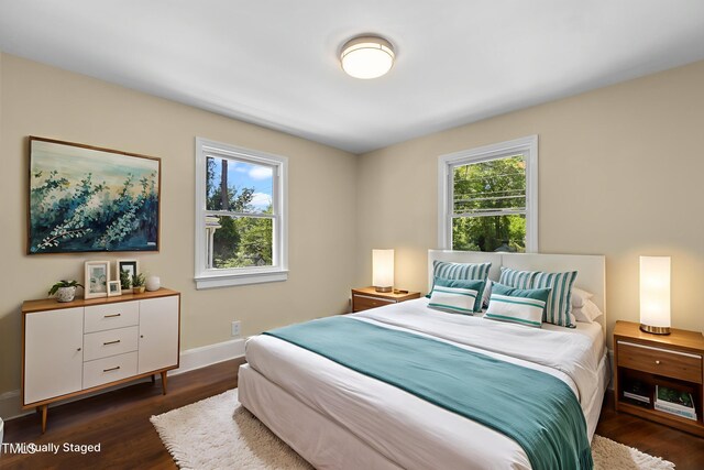 2712 Broad St, Durham, NC 27704 - bedroom featuring multiple windows, dark wood-type flooring, and baseboards