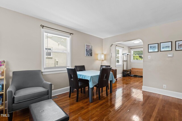 2710 Broad St, Durham, NC 27704 - dining area with arched walkways, baseboards, and wood-type flooring