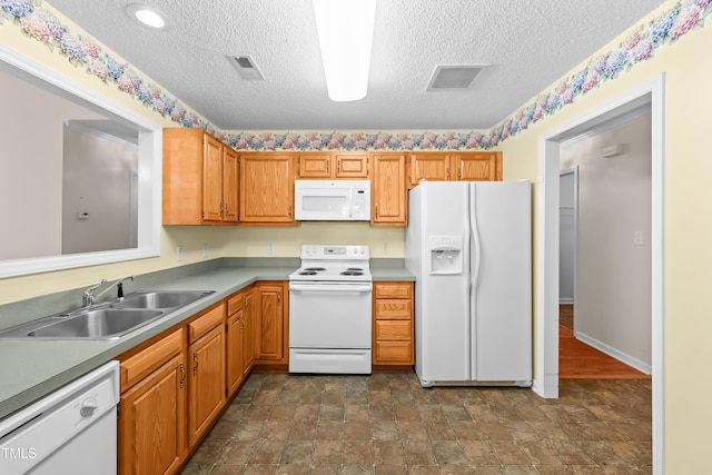 3027 Maple Unit T1, Burlington, NC 27215 - kitchen featuring white appliances, a sink, stone finish floors, a textured ceiling, and light countertops