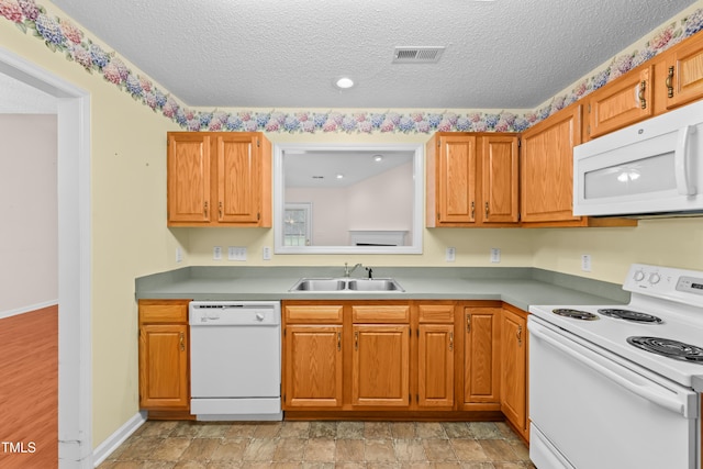 3027 Maple Unit T1, Burlington, NC 27215 - kitchen featuring white appliances, a sink, a textured ceiling, light countertops, and brown cabinets